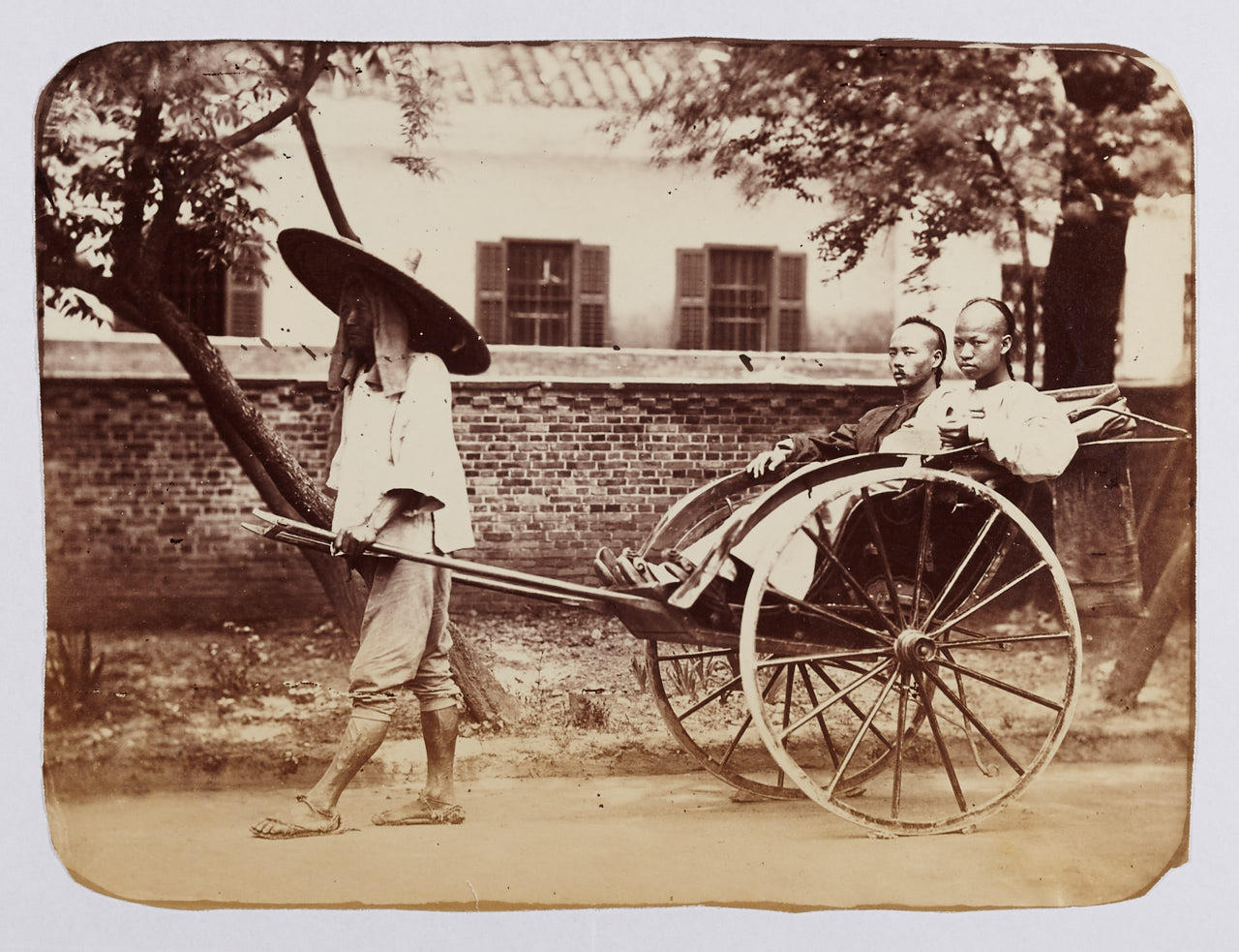 WILLIAM SAUNDERS (1832–1892) Two men in a rickshaw, China 1860s
