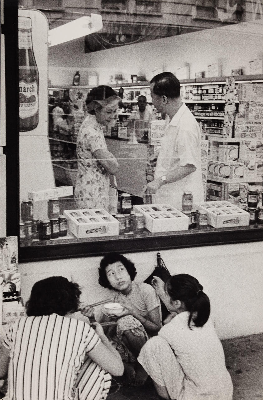 BRIAN BRAKE (1927–1988) Girls having their lunch in front of a supermarket, Hong Kong 1958