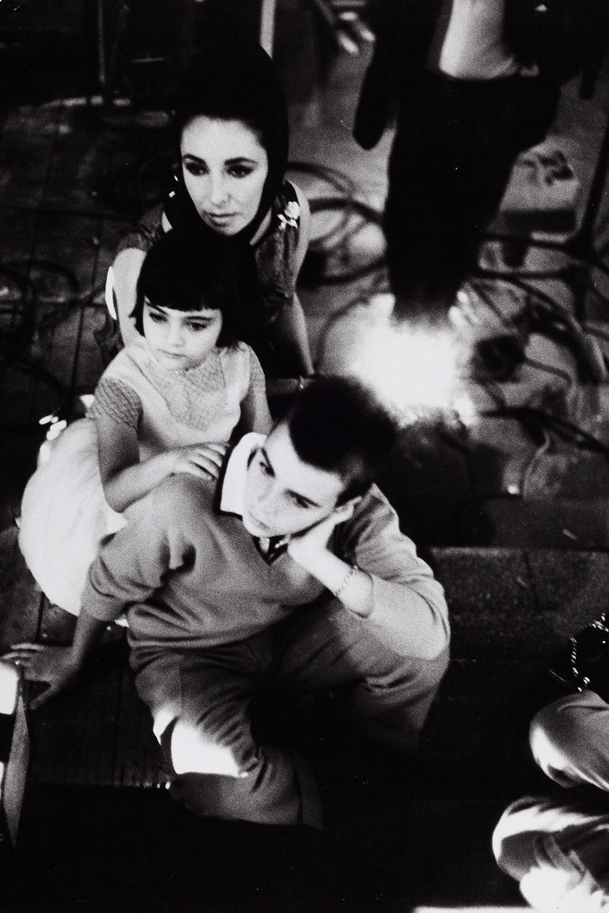 EVE ARNOLD (1912–2012) Elizabeth Taylor and her children watch from the shadows the murder scene in which Becket (Richard Burton is murdered, Shepperton Studios, UK 1963