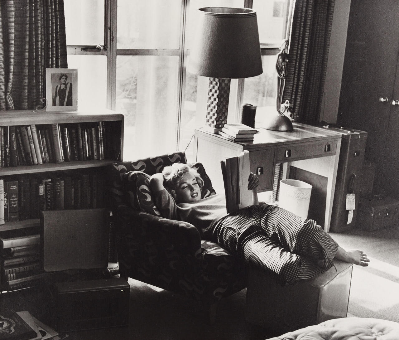 ANDRÉ DE DIENES (1913–1985) Marilyn reading in her apartment, 1952